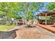 Inviting brick patio with outdoor kitchen, wooden deck and shade, perfect for entertaining at 506 S King Ave, Dunn, NC 28334