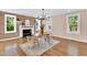 Bright dining room features hardwood floors, a wood accent wall, and ample natural light from surrounding windows at 506 S King Ave, Dunn, NC 28334