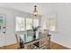 Charming dining area with natural light, wood table, and seating for four at 506 S King Ave, Dunn, NC 28334