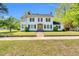 Charming two-story white home featuring black shutters and a welcoming front entrance with a brick walkway at 506 S King Ave, Dunn, NC 28334