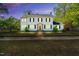 Elegant two-story home with lights on, brick walkway and manicured front lawn at twilight at 506 S King Ave, Dunn, NC 28334