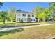 Beautiful two-story home boasts a large green lawn surrounded by mature trees, offering a serene setting at 506 S King Ave, Dunn, NC 28334