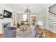 Comfortable living room with hardwood floors, fireplace, natural light, and a view into the adjacent dining area at 506 S King Ave, Dunn, NC 28334