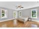 Spacious bedroom with a ceiling fan, windows, and hardwood floors at 506 S King Ave, Dunn, NC 28334
