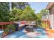 Backyard deck features sectional seating, dining set, and lush greenery in the background at 508 E Trinity Ave, Durham, NC 27701