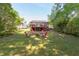 Expansive backyard with vibrant pink Adirondack chairs, a fire pit, and a spacious deck, great for outdoor entertainment at 508 E Trinity Ave, Durham, NC 27701