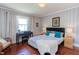 Bedroom features a large window with natural light and a plush bed with decorative pillows at 508 E Trinity Ave, Durham, NC 27701