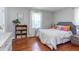 Cozy bedroom featuring a comfortable bed, hardwood floors, and decorative accents at 508 E Trinity Ave, Durham, NC 27701