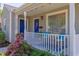 Cozy front porch featuring white railing, colorful landscaping, and comfortable seating with accent pillows at 508 E Trinity Ave, Durham, NC 27701