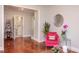 Bright interior showcasing hardwood floors, a comfortable armchair, and a glimpse into the adjacent bathroom at 508 E Trinity Ave, Durham, NC 27701