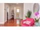 Bright interior view featuring hardwood floors, a comfy armchair, a decorative accent table, and a glimpse into another room at 508 E Trinity Ave, Durham, NC 27701