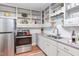 Kitchen with stainless steel appliances and sink with open shelving at 508 E Trinity Ave, Durham, NC 27701
