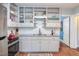 A kitchen featuring white cabinets and a stainless steel stove at 508 E Trinity Ave, Durham, NC 27701