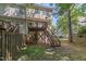 Exterior view of the backyard with a deck and steps to the lawn at 5420 Vista View Ct, Raleigh, NC 27612