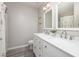 Bright bathroom with double sink vanity and white framed mirrors at 5420 Vista View Ct, Raleigh, NC 27612