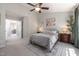 Spacious bedroom featuring soft carpet, ensuite bathroom, and lots of natural light at 5420 Vista View Ct, Raleigh, NC 27612