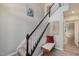 Bright stairway with carpeted steps, a bench, and modern artwork on the walls at 5420 Vista View Ct, Raleigh, NC 27612