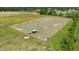 Aerial view of the property highlighting fencing, livestock pens and green pastures at 5423 Nc-39, Selma, NC 27576