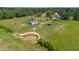 Aerial view of property featuring pastures, ponds and wooded areas at 5423 Nc-39, Selma, NC 27576