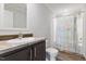 Bathroom with single sink vanity and combination shower-tub with colorful curtain at 5423 Nc-39, Selma, NC 27576