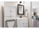 Charming bathroom boasts a white vanity with storage cabinet and a decorative framed mirror at 5423 Nc-39, Selma, NC 27576