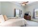 Comfortable bedroom featuring a ceiling fan, windows for natural light, and a nice dresser at 5423 Nc-39, Selma, NC 27576