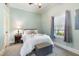Comfortable bedroom with a ceiling fan and natural light streaming through the large windows at 5423 Nc-39, Selma, NC 27576