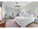 Bright bedroom with large windows, ceiling fan, and a view of the trees outside at 5423 Nc-39, Selma, NC 27576