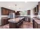 Modern kitchen with stainless steel appliances, granite countertops, and dark wood cabinets at 5423 Nc-39, Selma, NC 27576