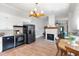 Open kitchen with black appliances, a brick fireplace, and adjacent dining area, creating a welcoming space for cooking and gathering at 5423 Nc-39, Selma, NC 27576