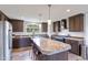 Open kitchen design with stainless steel appliances, granite counters, oversized island with seating and hard surface floors at 5423 Nc-39, Selma, NC 27576