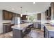 Open kitchen with stainless appliances, large island with seating, granite countertops, and hard surface floors at 5423 Nc-39, Selma, NC 27576
