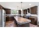 Open kitchen featuring a large island, stainless steel appliances, and modern lighting at 5423 Nc-39, Selma, NC 27576