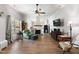 Cozy living room featuring a charming fireplace, ceiling fan and hardwood flooring at 5423 Nc-39, Selma, NC 27576