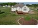 Exterior of home with rear deck, stone patio, and a well-manicured lawn at 55 Derwin Dr, Timberlake, NC 27583