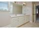Bathroom featuring a double sink vanity with a large mirror and neutral color palette at 55 Derwin Dr, Timberlake, NC 27583