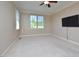 A carpeted bedroom featuring a ceiling fan, TV, and natural light at 55 Derwin Dr, Timberlake, NC 27583