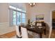 Elegant dining room featuring a large window and contemporary chandelier at 55 Derwin Dr, Timberlake, NC 27583