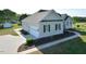 Exterior of home with an attached garage, manicured landscaping, and a paved driveway at 55 Derwin Dr, Timberlake, NC 27583
