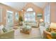 Sunroom with vaulted ceilings, bright lighting, and neutral furniture at 55 Derwin Dr, Timberlake, NC 27583