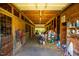 Barn interior with horse stalls, wooden beams and miscellaneous boxes at 5916&5918 Laws Farm Rd, Rougemont, NC 27572