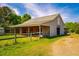 Barn featuring an attached garage and covered stalls with a fenced yard, perfect for farm use at 5916&5918 Laws Farm Rd, Rougemont, NC 27572