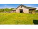 Barn in a grass field with blue skies on a sunny day at 5916&5918 Laws Farm Rd, Rougemont, NC 27572