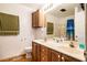 Bathroom with double vanity sinks, wood cabinetry, and a shower-tub combo at 5916&5918 Laws Farm Rd, Rougemont, NC 27572