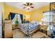 Bright bedroom with yellow walls, ceiling fan, and cozy furnishings at 5916&5918 Laws Farm Rd, Rougemont, NC 27572