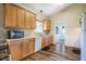 Galley-style kitchen features light wood cabinets and stainless steel appliances at 5916&5918 Laws Farm Rd, Rougemont, NC 27572