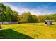 Picturesque grassy yard surrounded by mature trees, offering privacy, space and serene outdoor setting at 5916&5918 Laws Farm Rd, Rougemont, NC 27572
