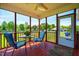 Relaxing screened porch with seating, offering a tranquil outdoor space at 5916&5918 Laws Farm Rd, Rougemont, NC 27572