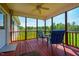 Relaxing screened porch features wood flooring and ceiling fan, with views of the backyard and adjacent horse pasture at 5916&5918 Laws Farm Rd, Rougemont, NC 27572