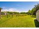 Yard with a house, barn, shed, and fences on a sunny day at 5916&5918 Laws Farm Rd, Rougemont, NC 27572